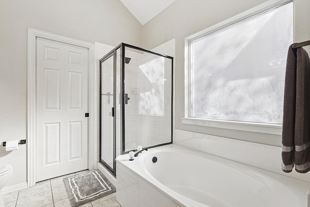 bathroom featuring plus walk in shower, vaulted ceiling, and tile patterned floors