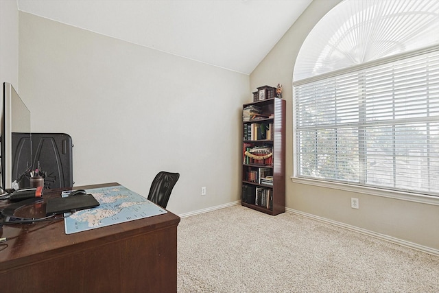 office featuring lofted ceiling and light colored carpet