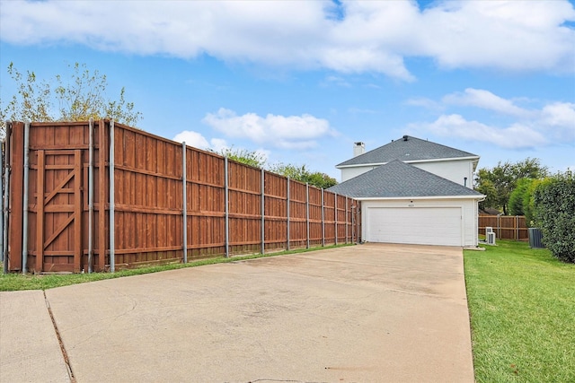 exterior space with a garage and central AC unit