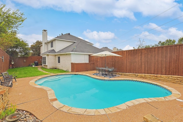 view of pool featuring a yard and a patio area