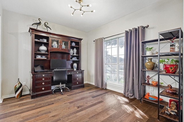 home office featuring dark hardwood / wood-style flooring, a notable chandelier, and a wealth of natural light