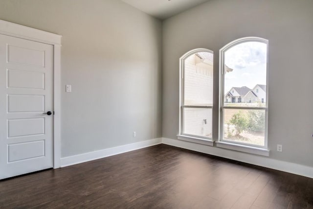 unfurnished room with dark hardwood / wood-style floors