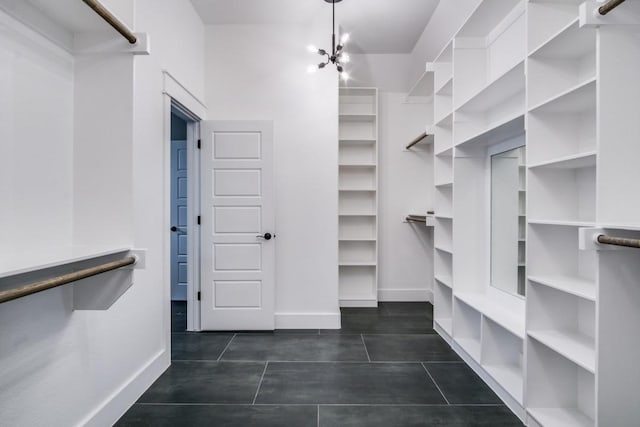 spacious closet featuring an inviting chandelier