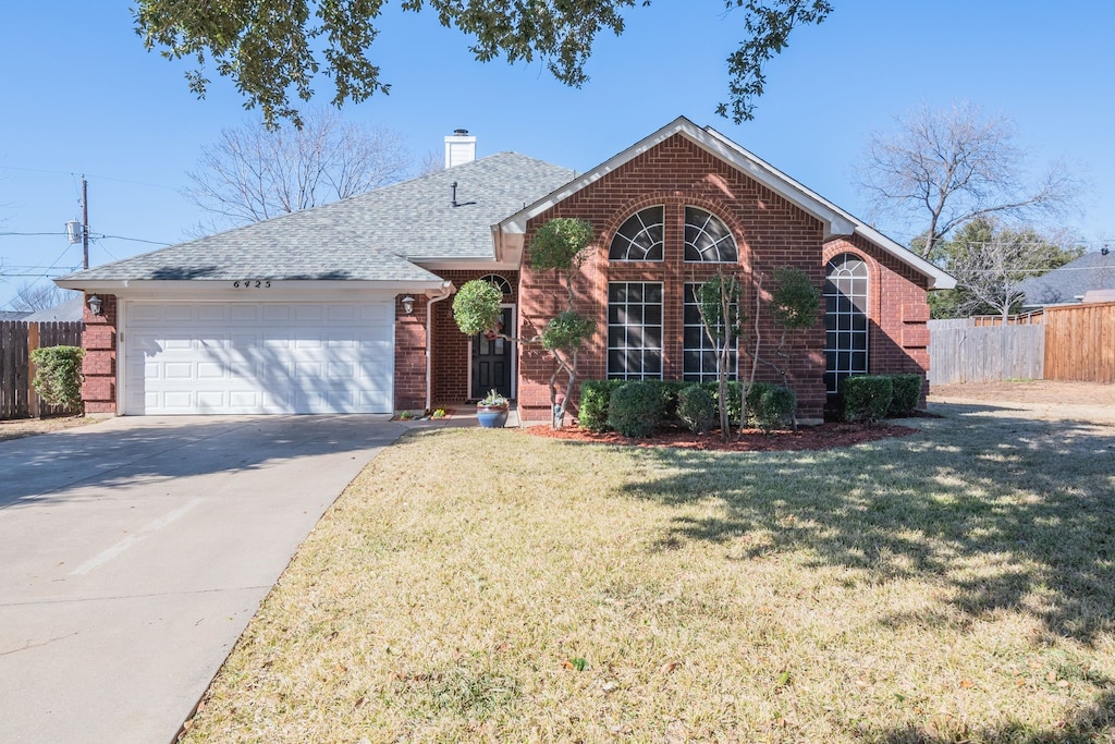 front facade featuring a garage and a front yard