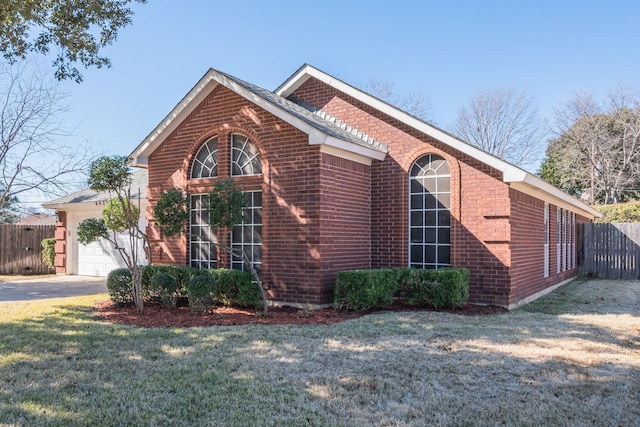 view of side of home with a garage and a lawn