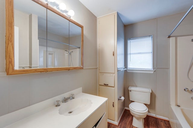 full bathroom featuring vanity, hardwood / wood-style flooring, bathtub / shower combination, and toilet