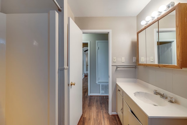 bathroom with hardwood / wood-style flooring and vanity