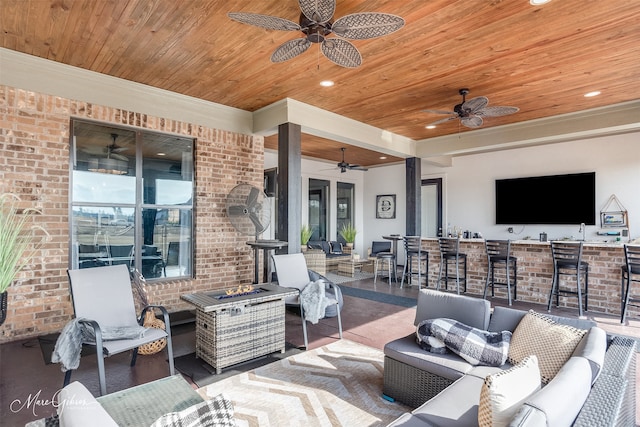 view of patio featuring exterior bar and an outdoor living space with a fire pit