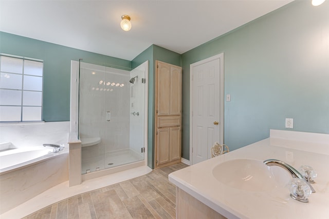 bathroom featuring vanity, separate shower and tub, and hardwood / wood-style floors