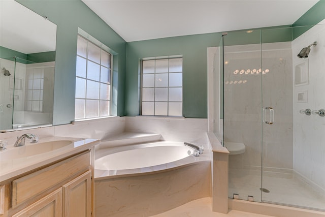 bathroom featuring plus walk in shower and vanity