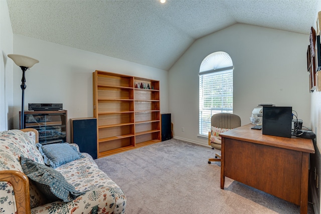 carpeted home office with vaulted ceiling and a textured ceiling