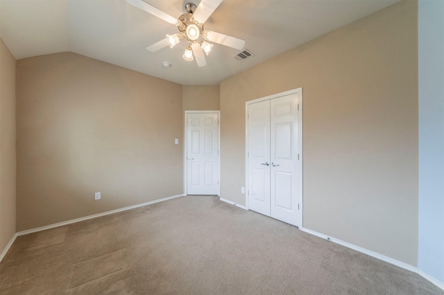 unfurnished bedroom featuring baseboards, visible vents, carpet floors, ceiling fan, and a closet