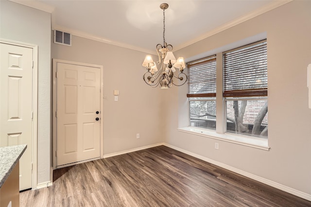 unfurnished dining area featuring crown molding, a notable chandelier, and hardwood / wood-style flooring