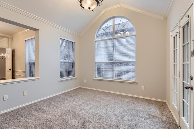 spare room featuring vaulted ceiling, ornamental molding, french doors, and carpet flooring