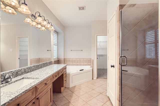 bathroom with vanity, shower with separate bathtub, and tile patterned flooring