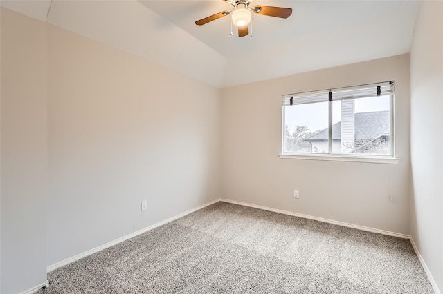 empty room with vaulted ceiling, carpet floors, and ceiling fan