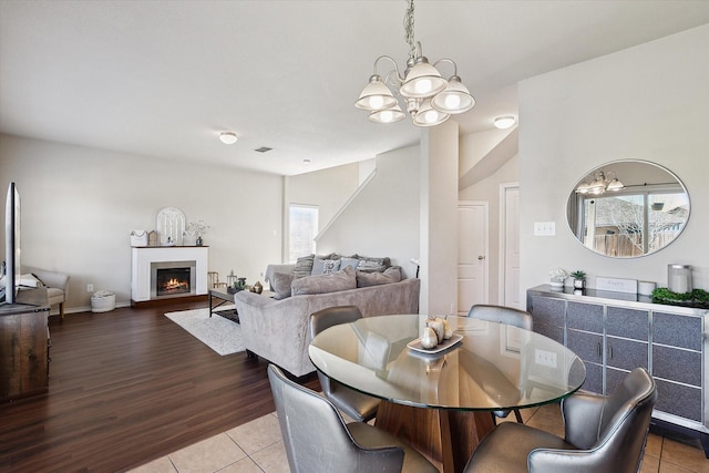 dining area with an inviting chandelier and tile patterned floors