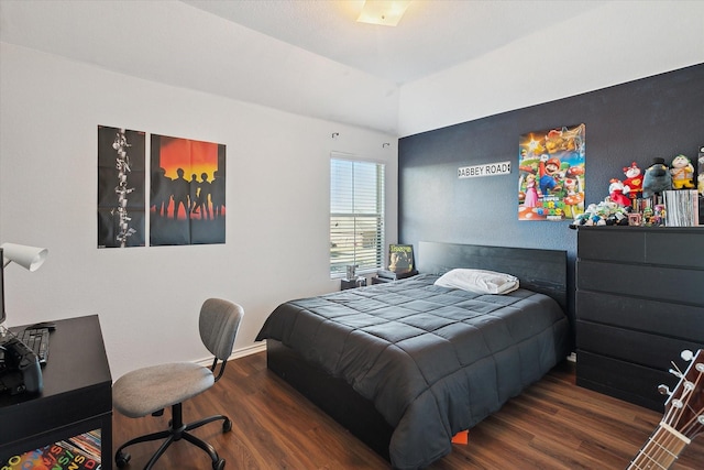 bedroom with dark hardwood / wood-style flooring and lofted ceiling