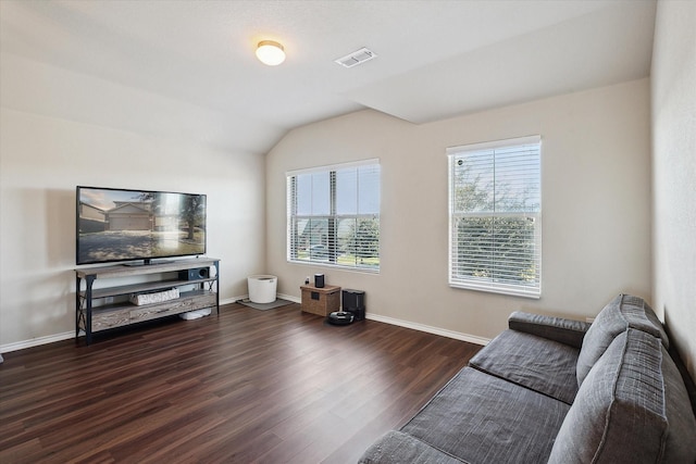 living room featuring vaulted ceiling and dark hardwood / wood-style flooring