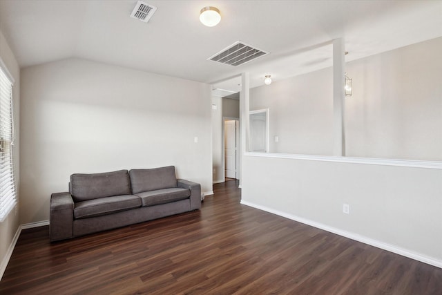 living room featuring lofted ceiling and dark hardwood / wood-style floors