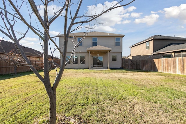 rear view of house with a yard