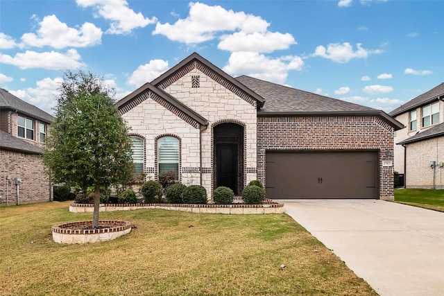 french country style house featuring a garage and a front lawn