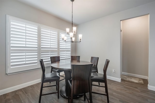 dining area featuring dark hardwood / wood-style floors and a notable chandelier