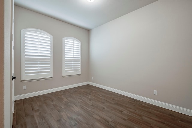 spare room featuring dark hardwood / wood-style flooring