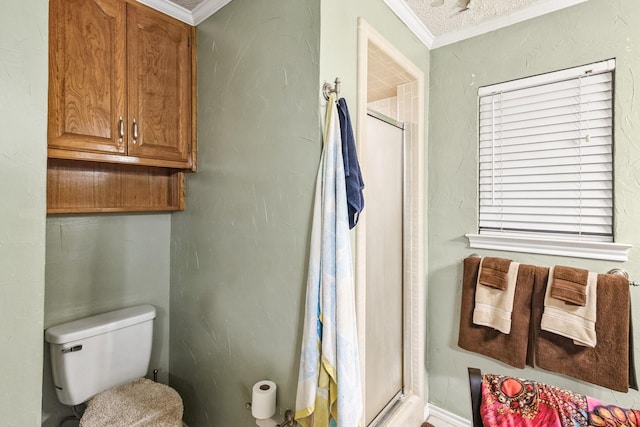 bathroom with a shower with door, ornamental molding, and toilet