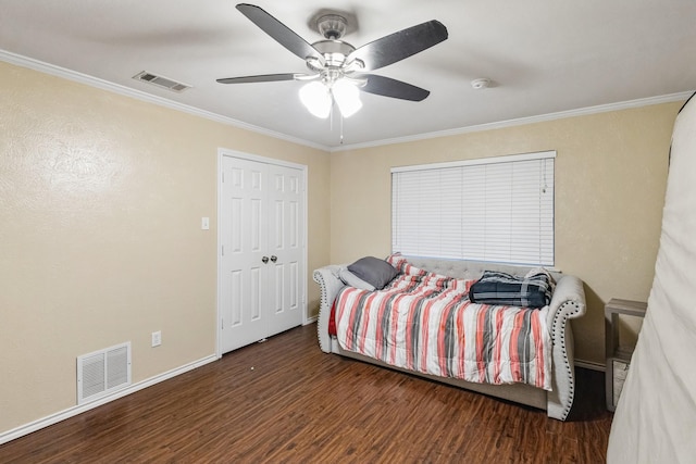 bedroom with dark hardwood / wood-style flooring, ornamental molding, and ceiling fan