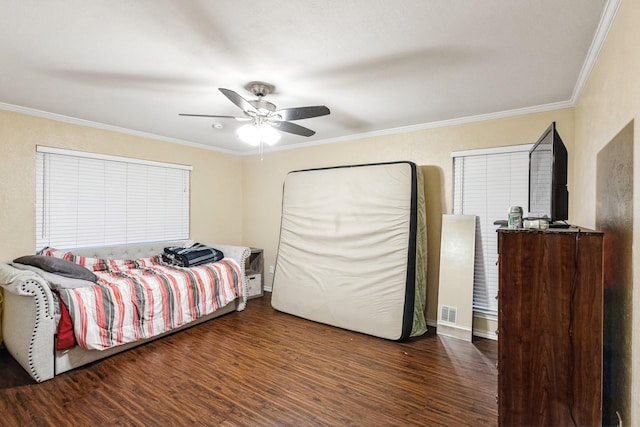 bedroom with ceiling fan, ornamental molding, and dark hardwood / wood-style flooring