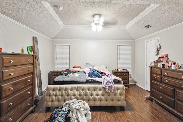 bedroom featuring dark hardwood / wood-style flooring, crown molding, vaulted ceiling, and a raised ceiling