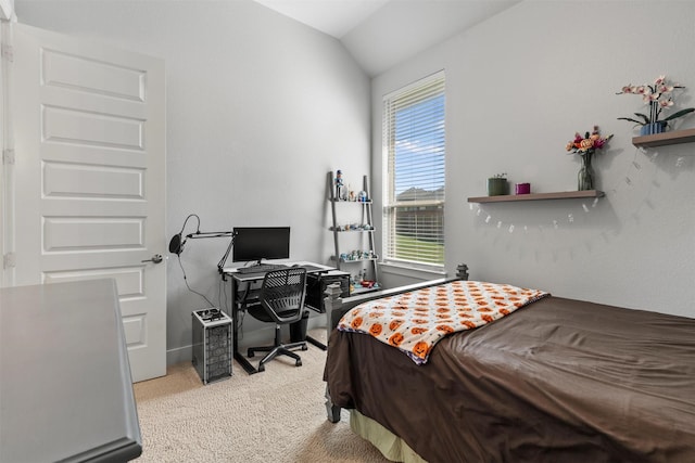 carpeted bedroom with lofted ceiling