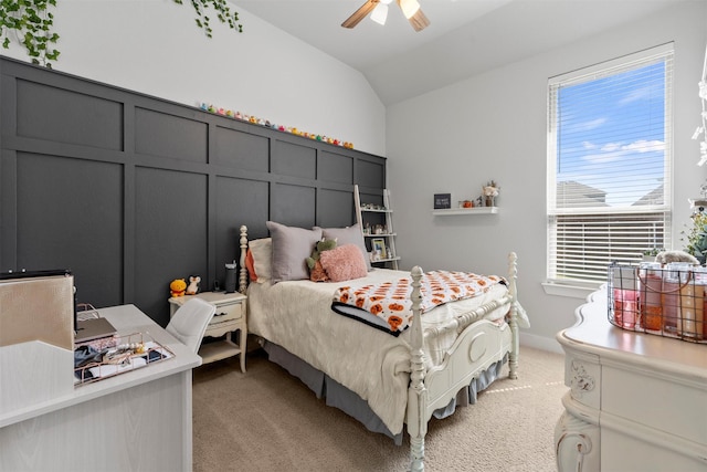 bedroom with vaulted ceiling, light colored carpet, and ceiling fan