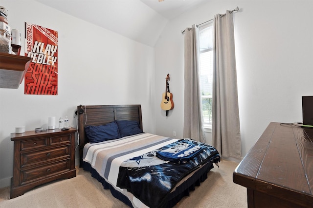 bedroom featuring light colored carpet and lofted ceiling