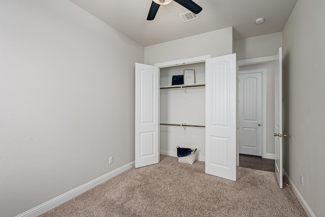 unfurnished bedroom featuring carpet, ceiling fan, and a closet