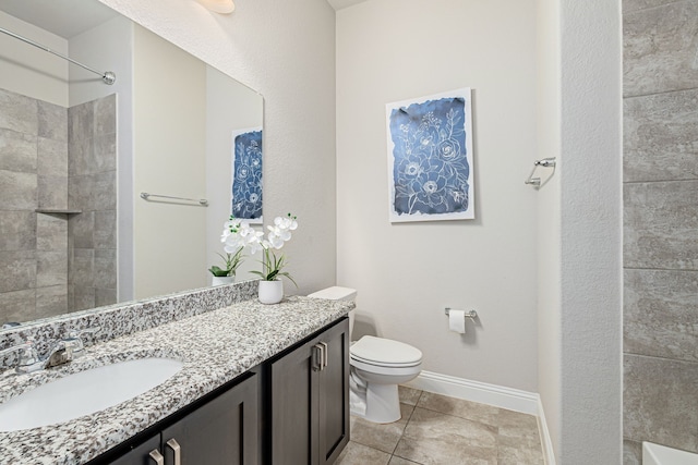 bathroom with tile patterned flooring, vanity, tiled shower, and toilet