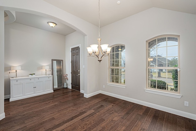 unfurnished dining area with an inviting chandelier, dark hardwood / wood-style flooring, and vaulted ceiling