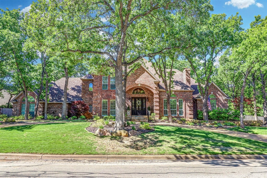 tudor-style house with a front yard