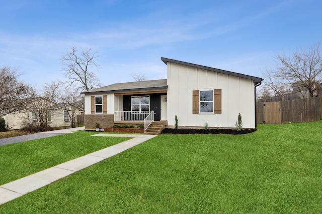 view of front of house with covered porch and a front yard