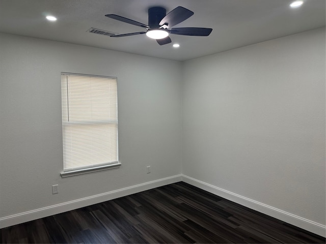 spare room featuring ceiling fan and dark hardwood / wood-style floors