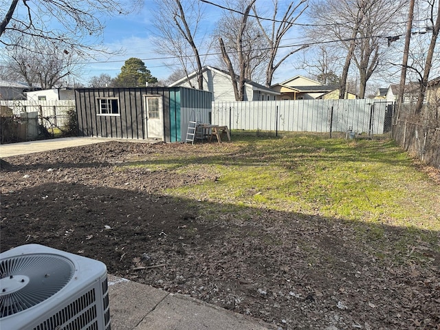 view of yard with an outdoor structure and central air condition unit