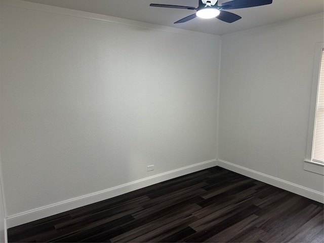 spare room featuring dark wood-type flooring and ceiling fan