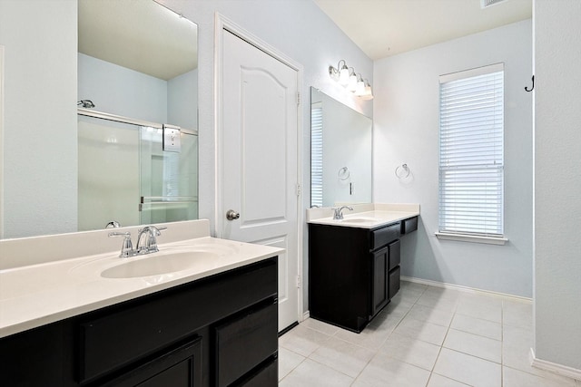 bathroom with vanity, a shower with shower door, and tile patterned flooring