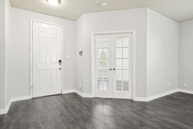 entrance foyer with dark hardwood / wood-style flooring and french doors