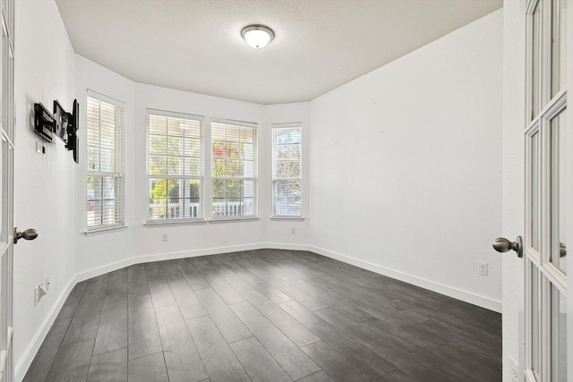 spare room with dark hardwood / wood-style floors