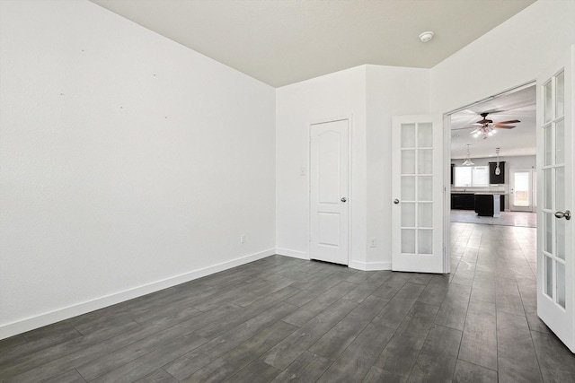 empty room with french doors and dark hardwood / wood-style flooring