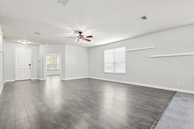 spare room with dark wood-type flooring and ceiling fan