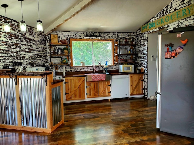 kitchen with sink, decorative light fixtures, stainless steel refrigerator, dark hardwood / wood-style flooring, and white dishwasher