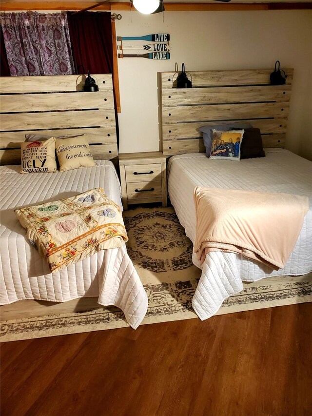 bedroom with ceiling fan, ornamental molding, and dark hardwood / wood-style floors